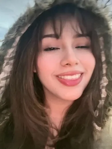 Woman laughing in a fur-trimmed hood