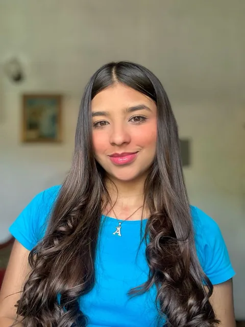 Woman in a blue T-shirt with long wavy hair